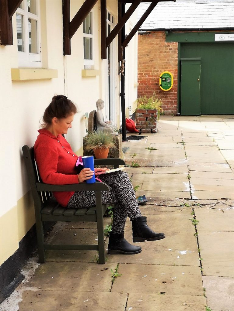 woman reading yard