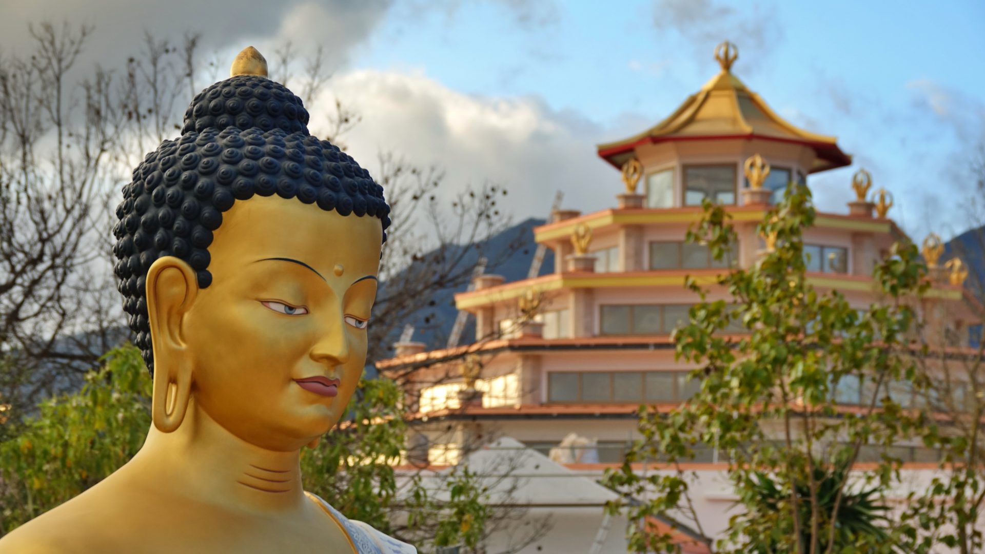 5star malaga kadampa temple Buddha Shakyamuni statue clouds mountains trees daytime outdoors ginaw