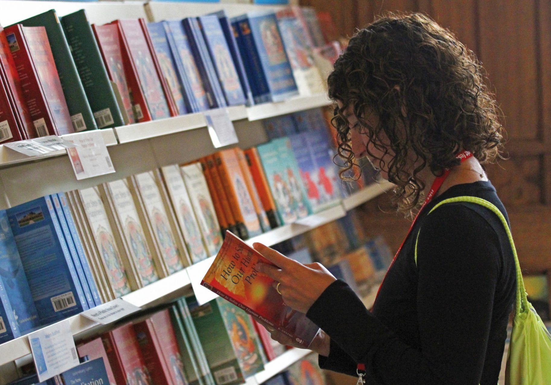A person reading the books in the bookstore and gift shop.